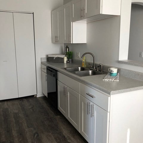 bright white clean cabinets, wood flooring, premium countertops and appliances at regency apartments in Bettendorf Iowa